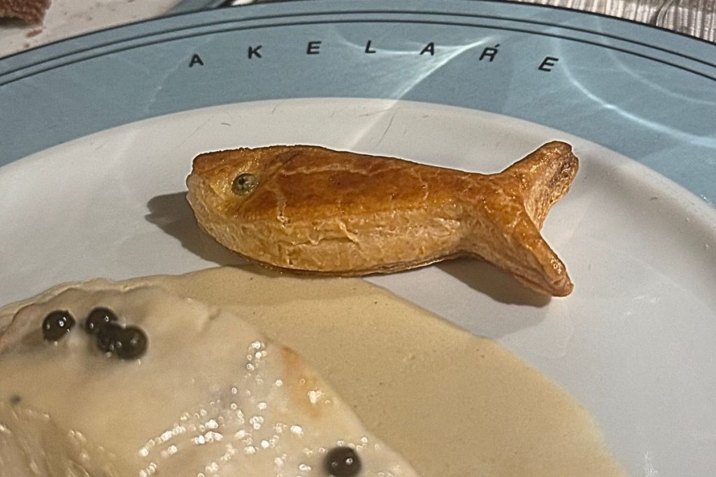 Signature hake in green sauce with fish-shaped bread at Akelarre, Pedro Subijana's 3-Michelin-star restaurant