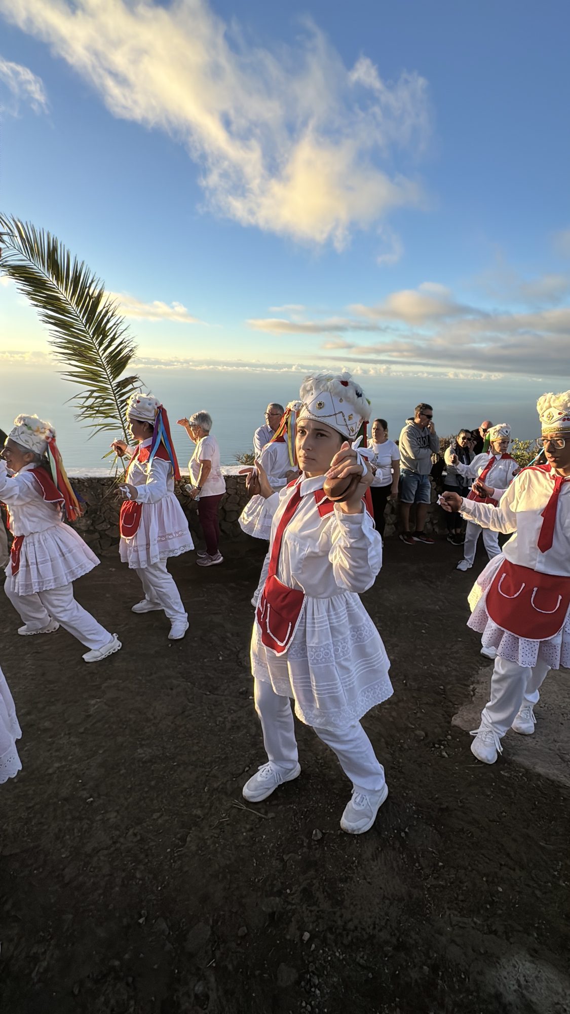 Dancer in traditional red and white dress with ribbons at the Fiesta de la Virgen de la Peña, El Hierro