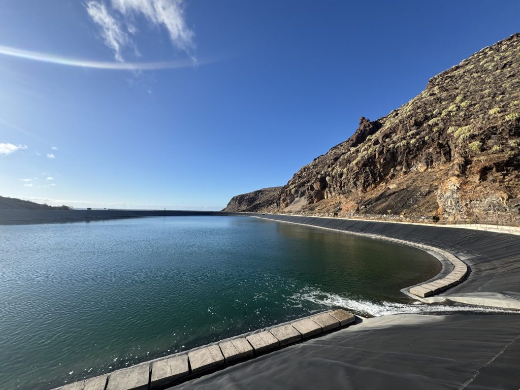 Upper water reservoir of the Gorona del Viento wind-hydro plant beneath a volcanic slope, El Hierro