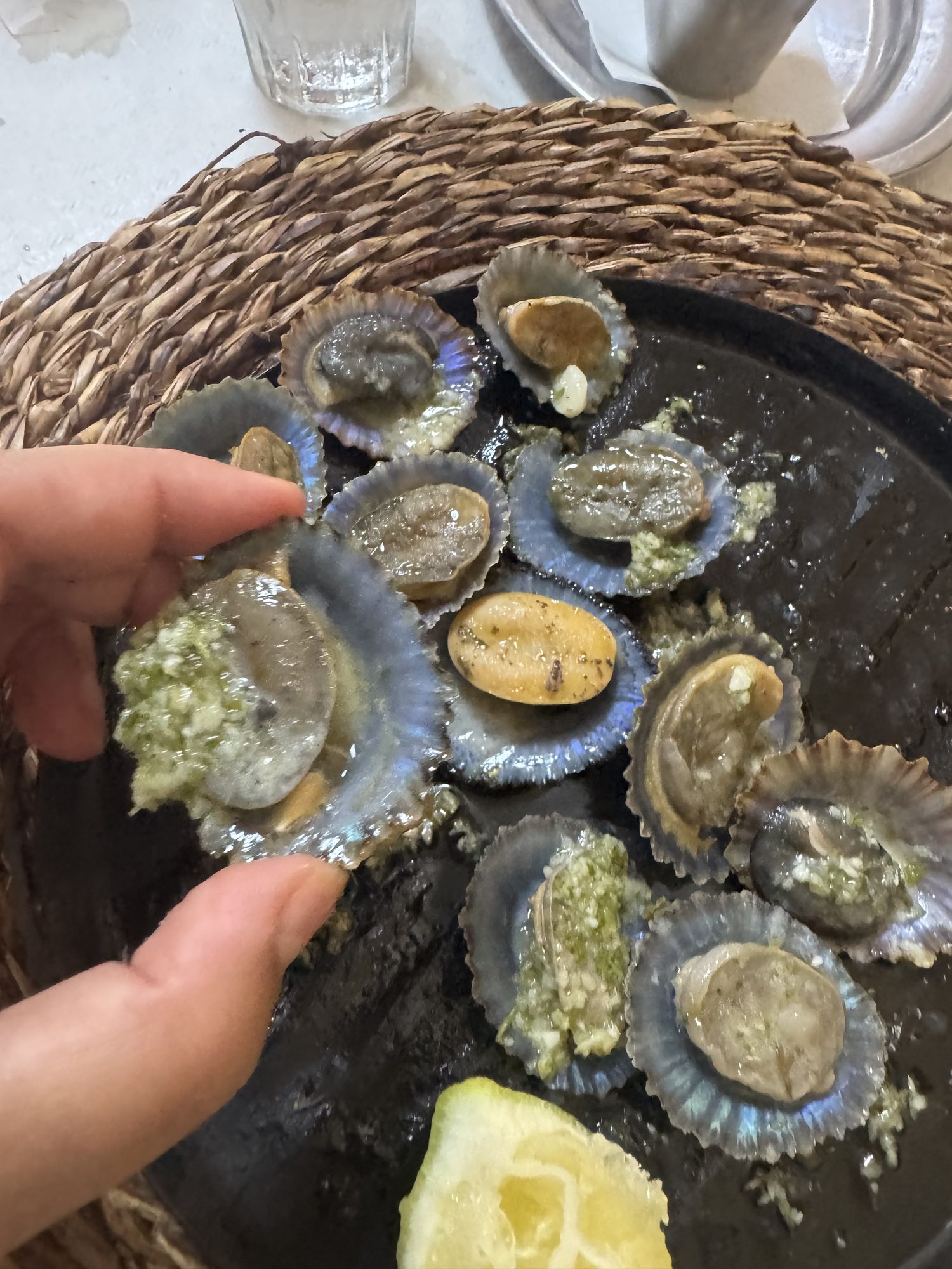 Grilled limpets with green sauce and a lemon wedge, El Hierro