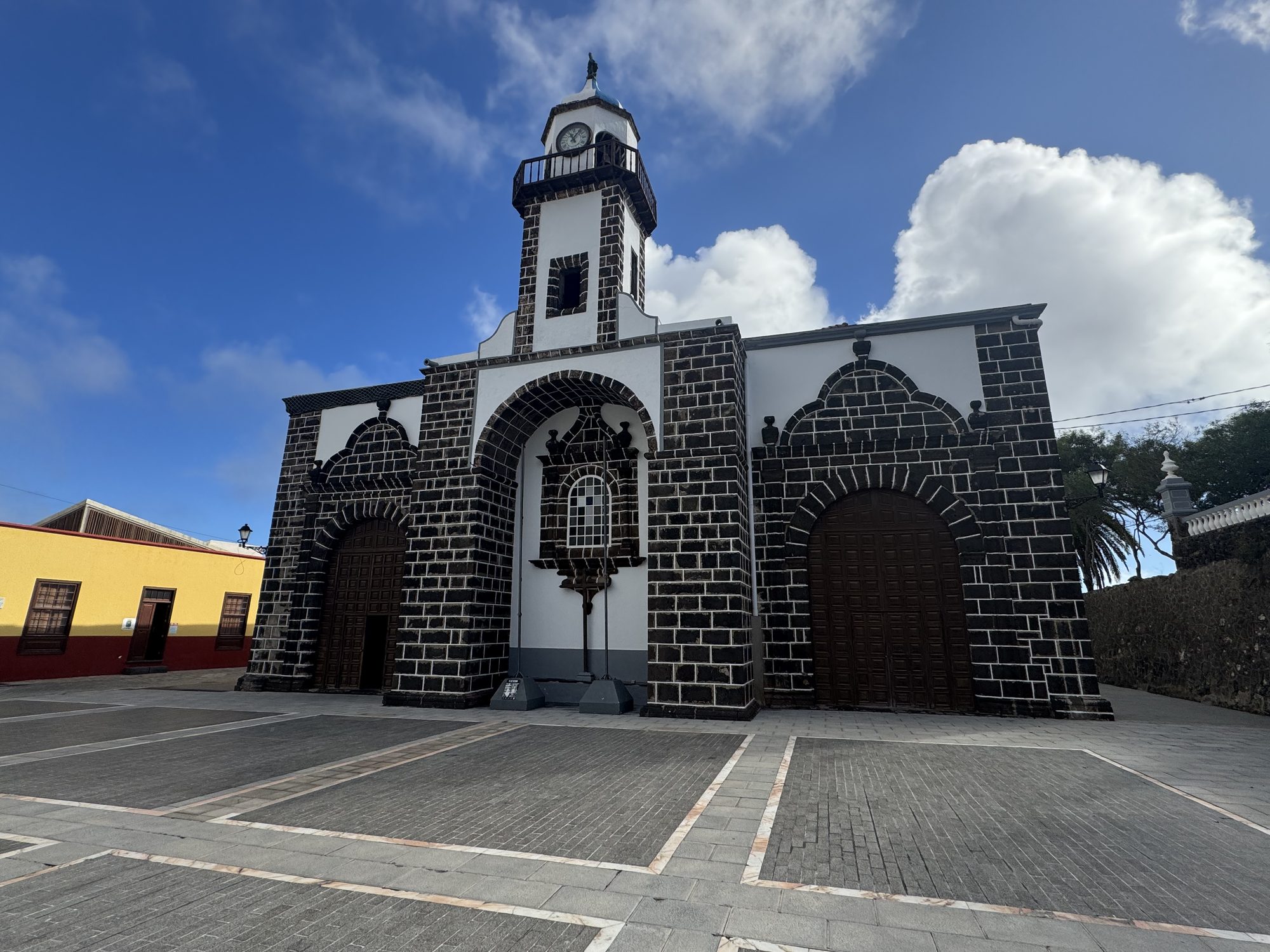 Church built of dark volcanic stone with white trim in Valverde, El Hierro